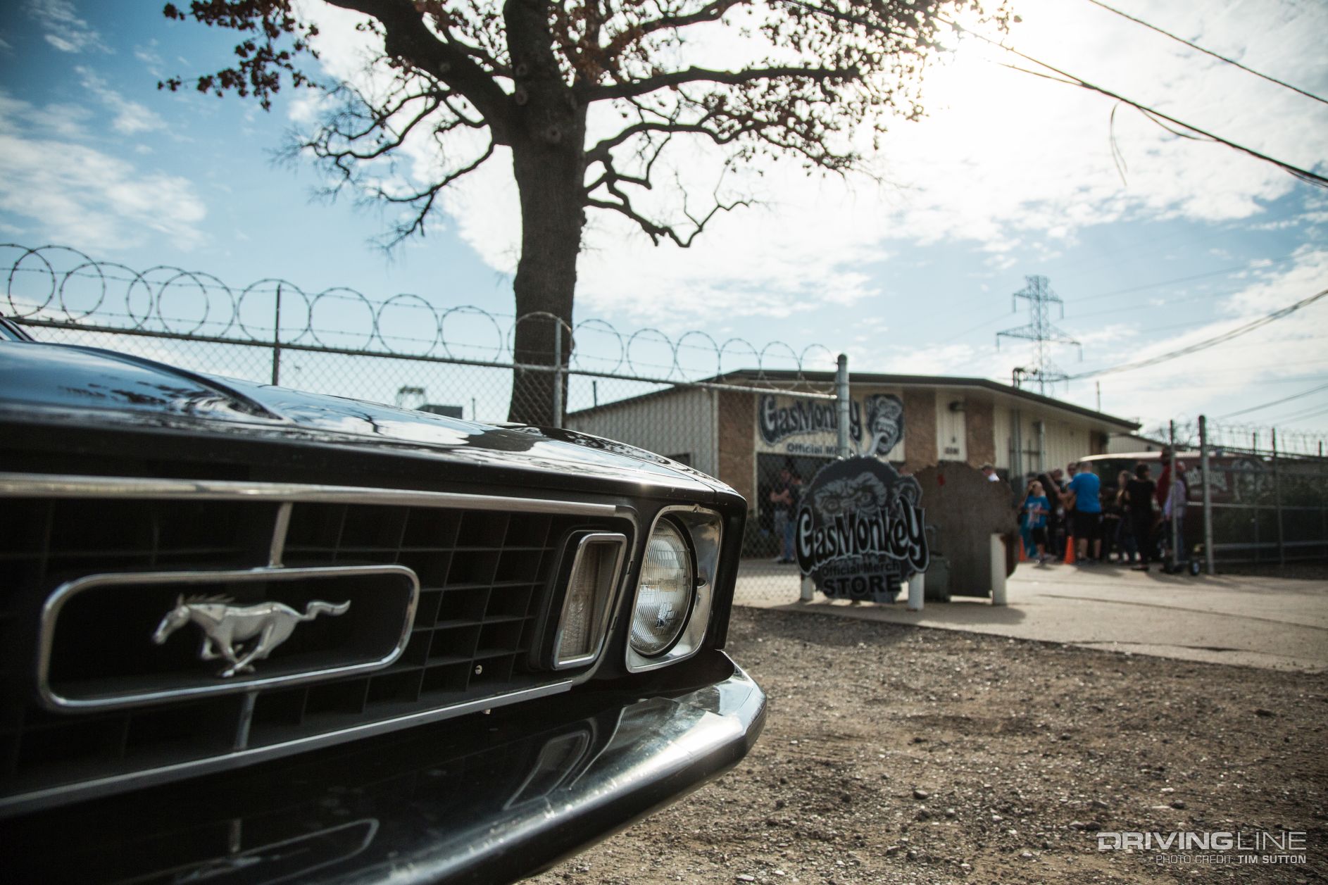 Front grille of a classic Mustang in front of the Gas Monkey Garage exterior