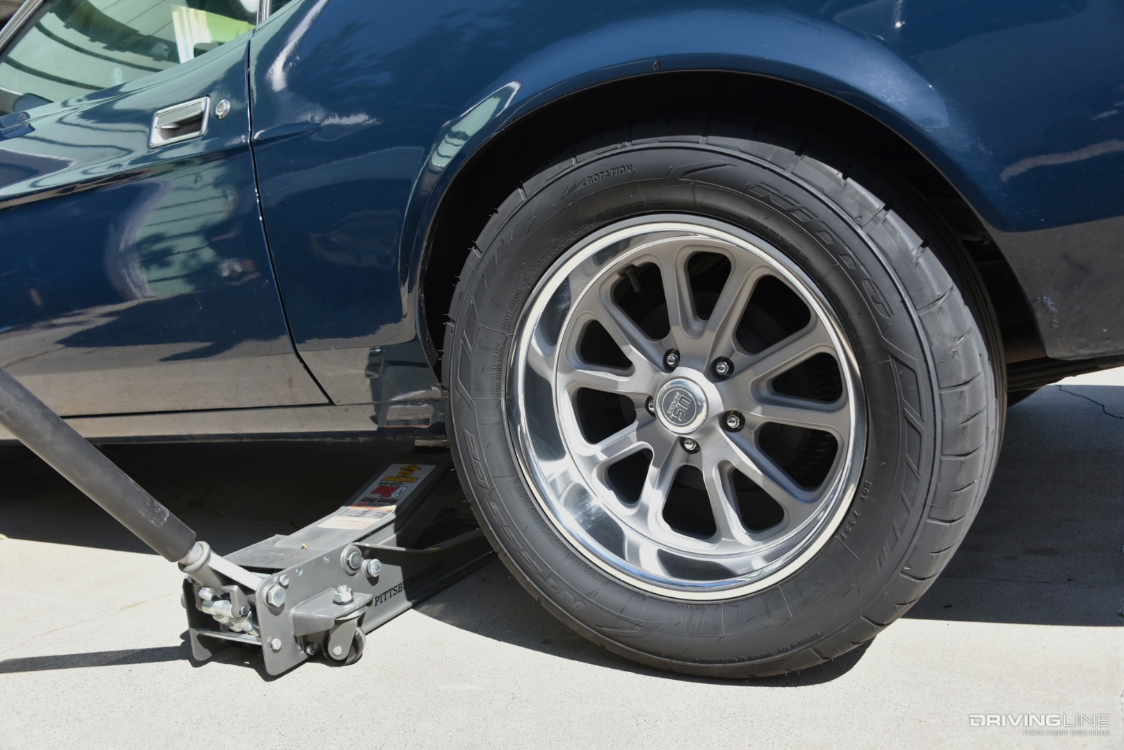 Nitto NT555 G2 tire on custom wheel with floor jack