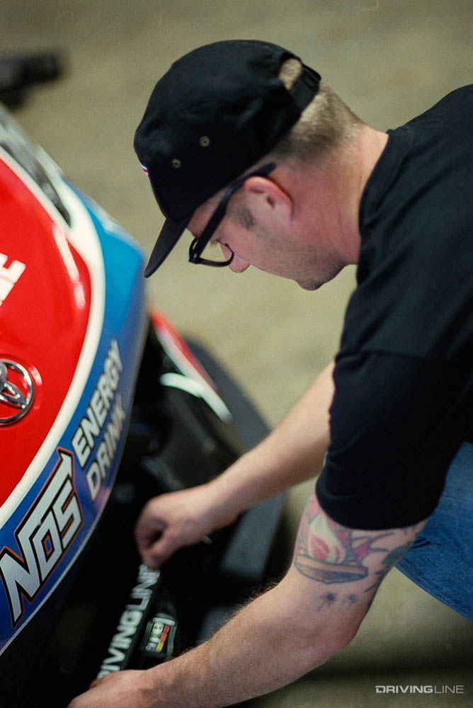 Ryan Tuerck applying Driving Line sticker