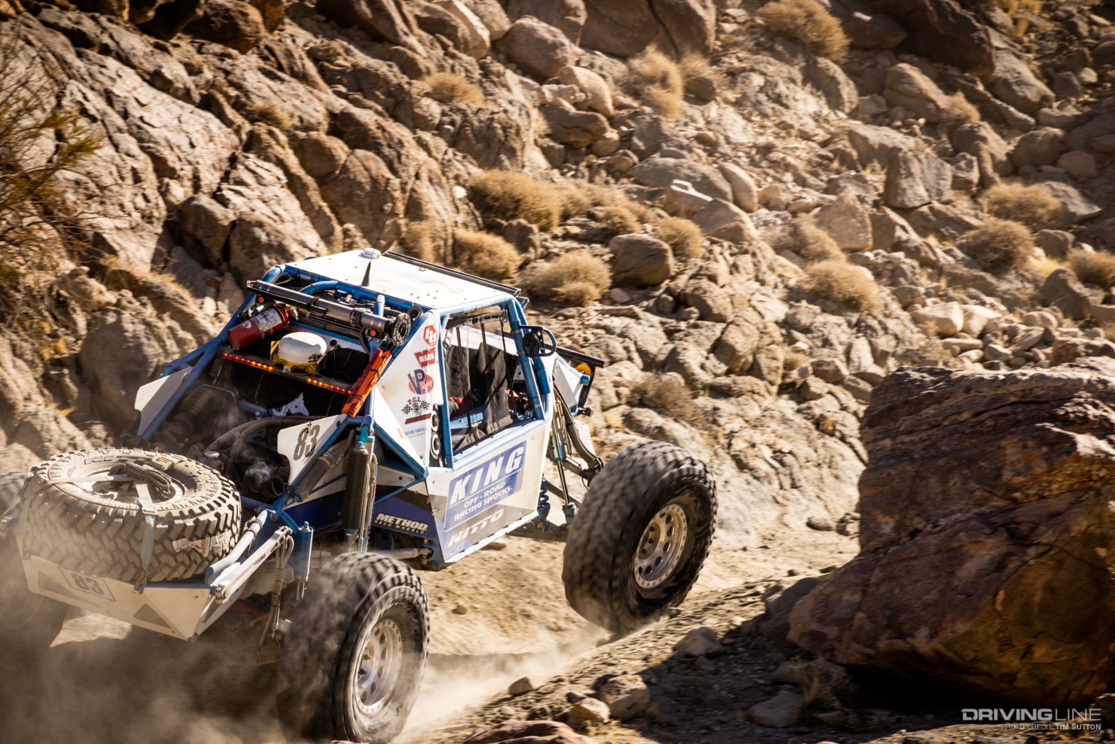 Raul Gomez driving in between large rocks