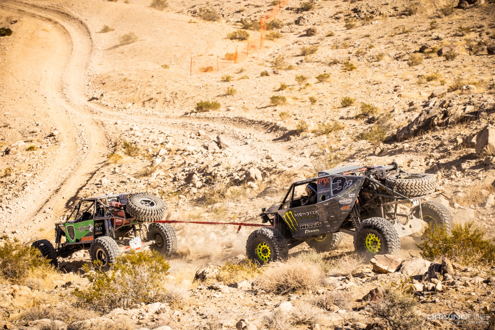 Wayland Campbell getting towed down a hill by another driver