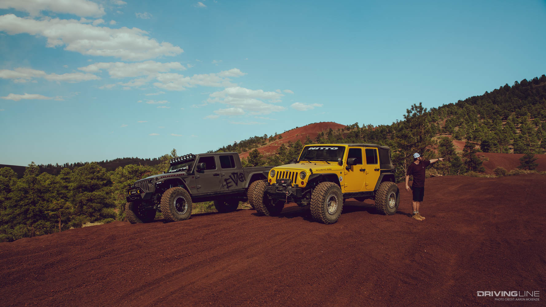 Randy Wilcox pointing in Cinders OHV Area next to two Jeeps
