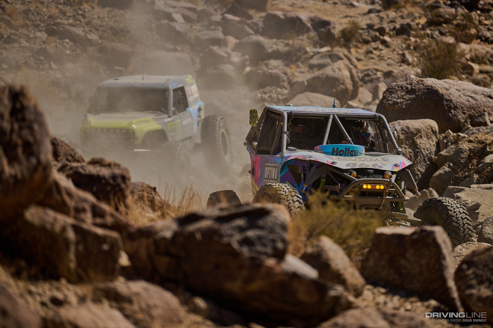 Jason Blanton driving down a rocky canyon ahead of Vaughn Gittin Jr.