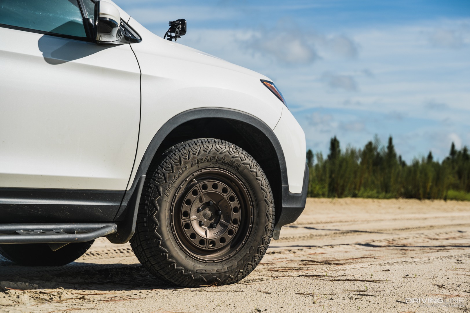 Detail of Honda Ridgeline front wheel with Nitto Nomad Grappler tires