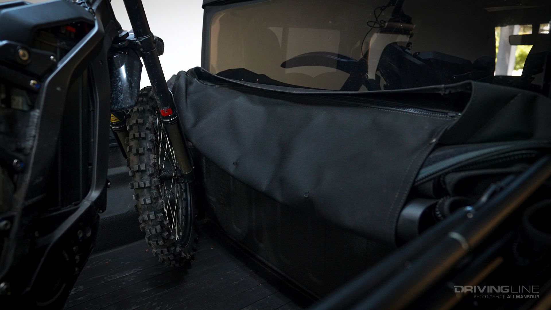 Front wheel of motorcycle in bed of Jeep Gladiator Bestop Supertop For Trucks 2 Bed Cover