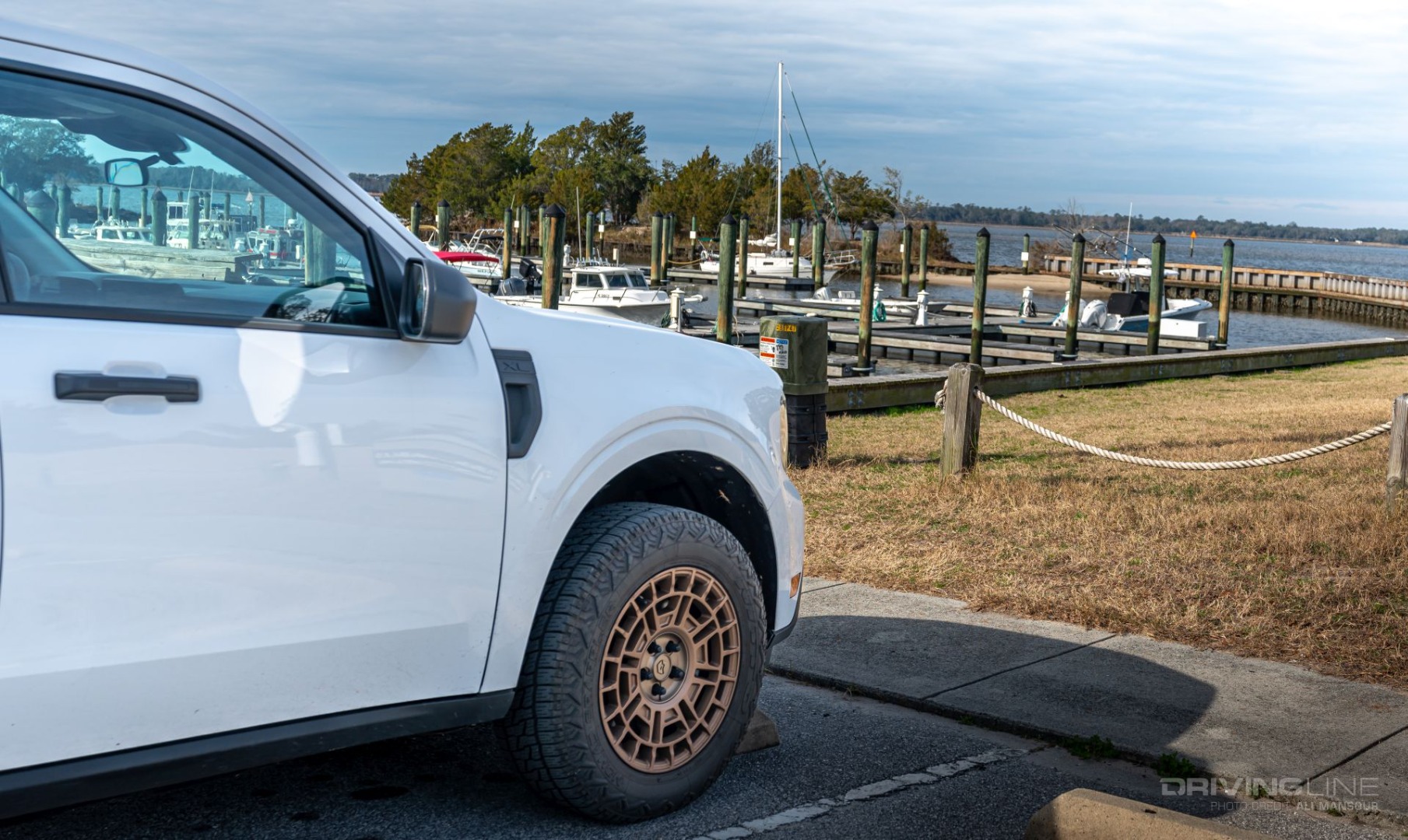 Front driver side of white 2022 Ford Maverick XL Hybrid on Nitto Tire Nomad Grappler