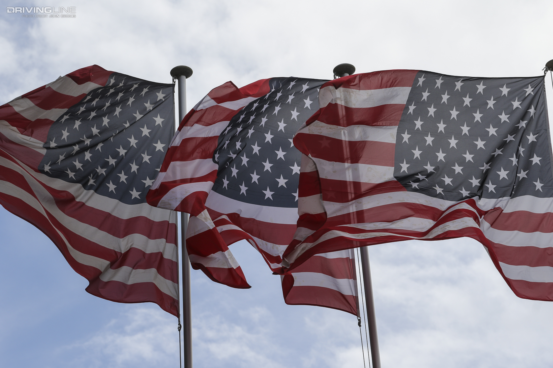 three American flags waving in the wind