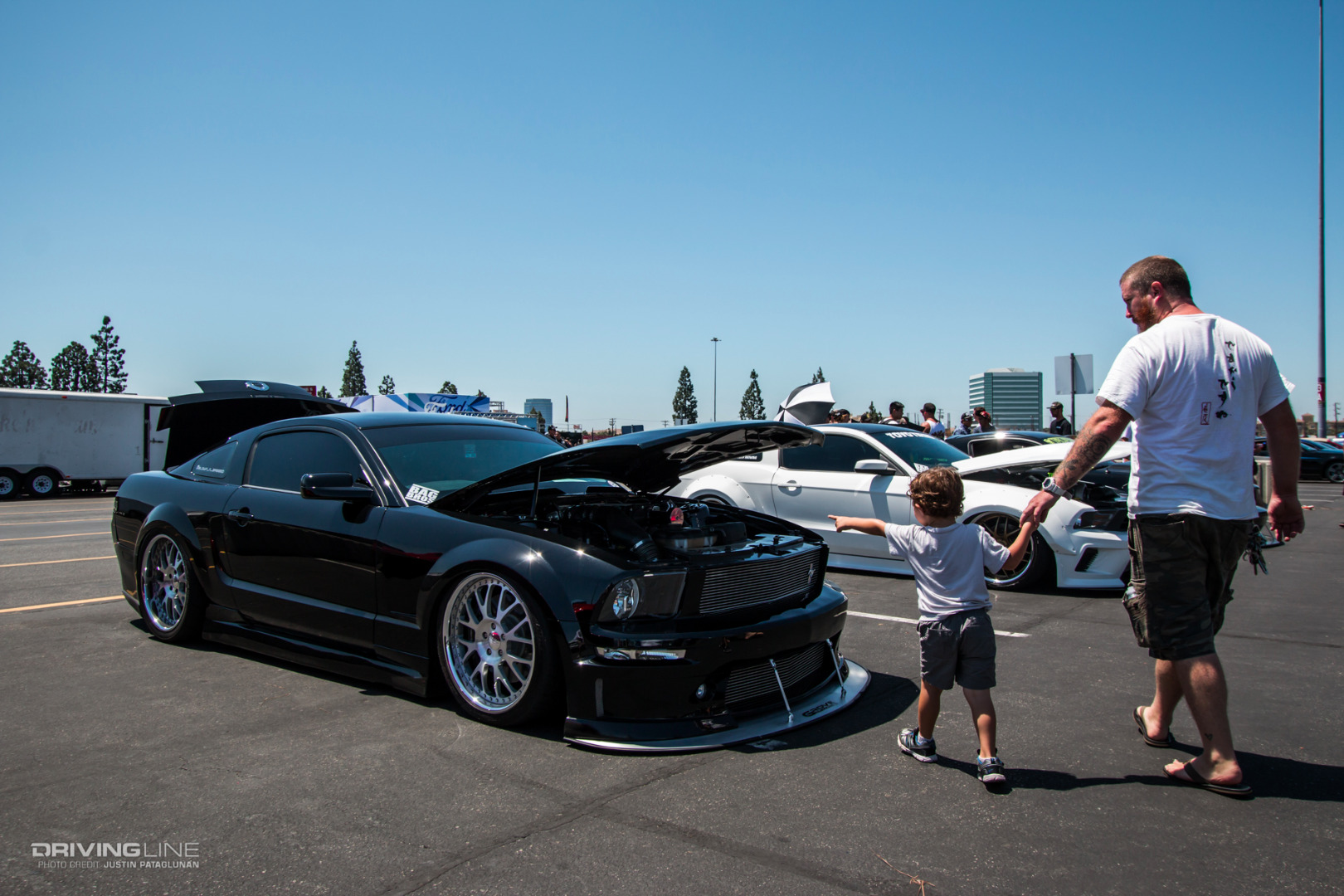 father and son looking at cars