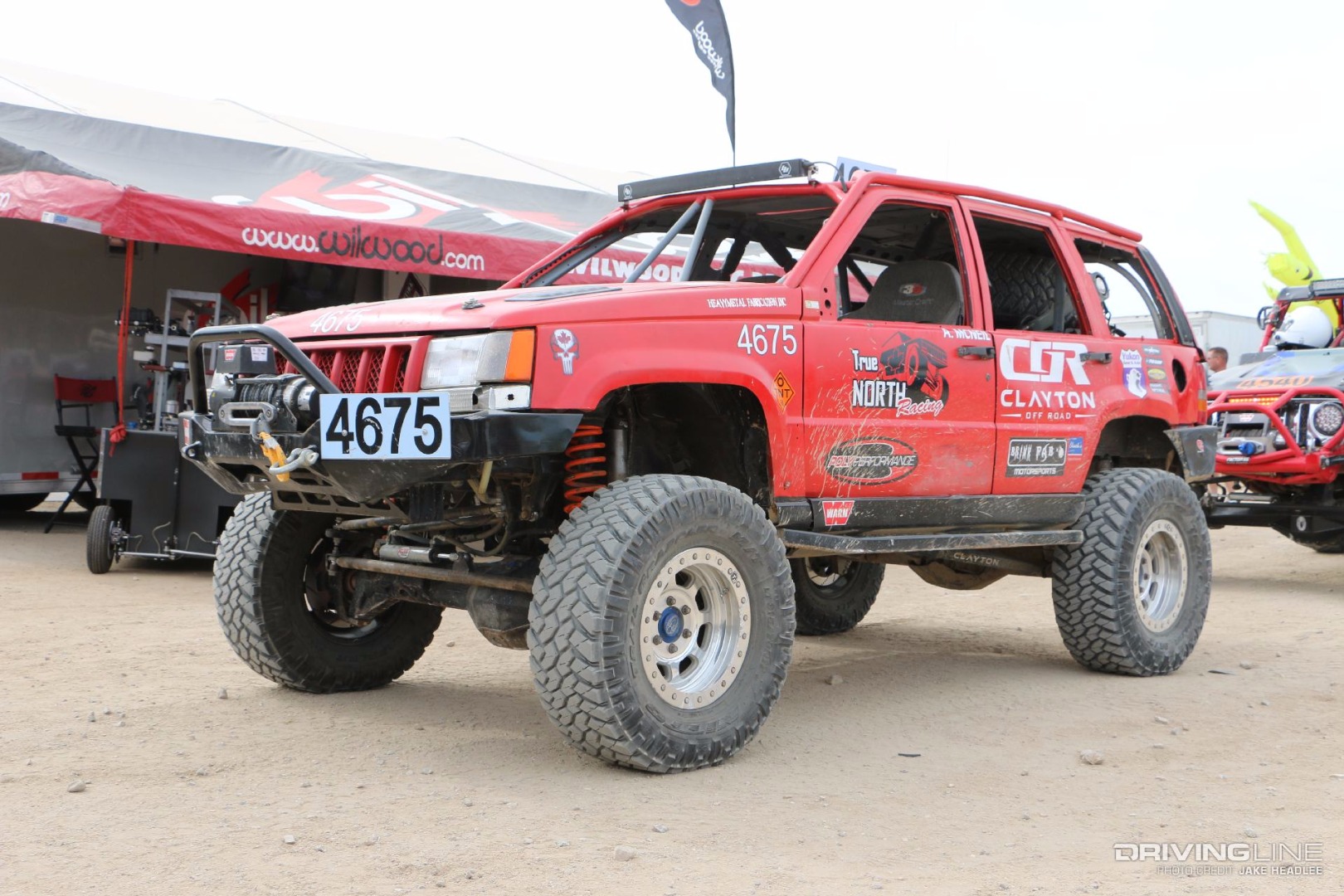 Red Jeep Grand Cherokee on a lift and with a winch