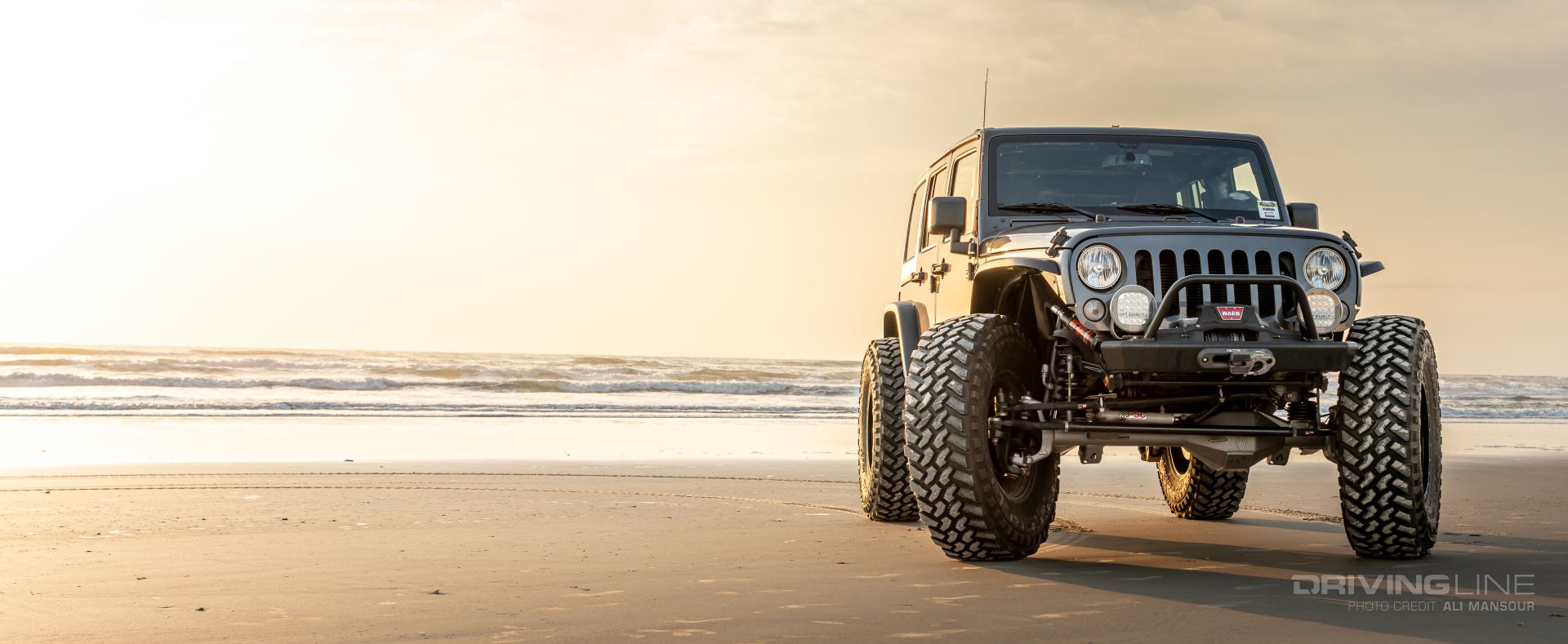 Jeep Wrangler JK on 42s Nitto Trail Grappler front view on beach Erik Miller