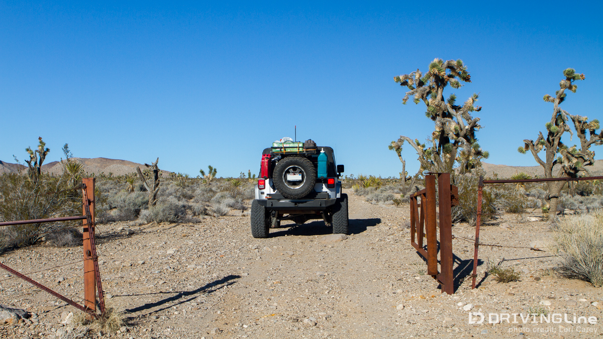 Jeep Wrangler driving through a gate