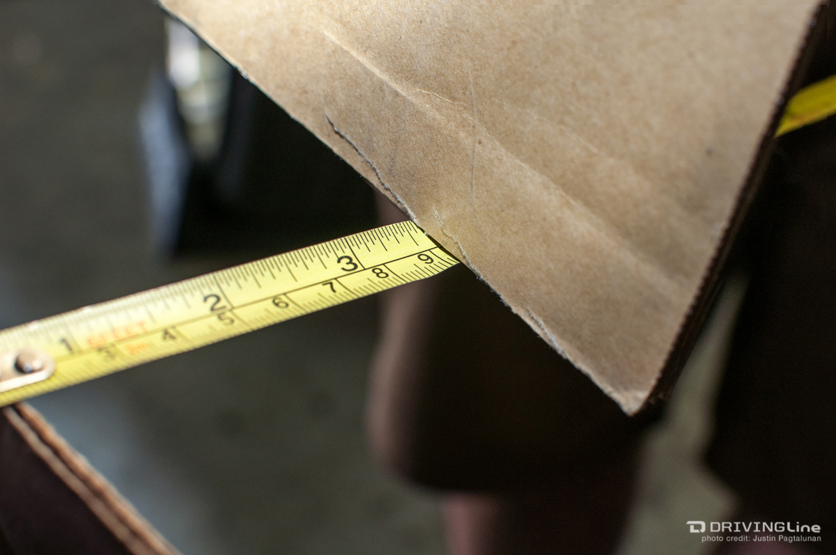 Tape measure next to a piece of cardboard