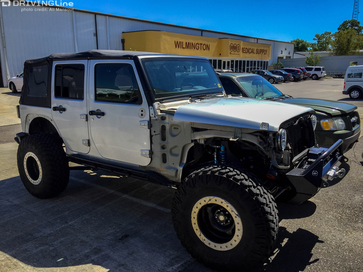 Silver Jeep Wrangler parked outside