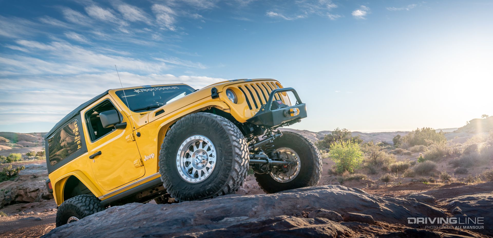 Jeep Wrangler on Nittos climbing rock from front