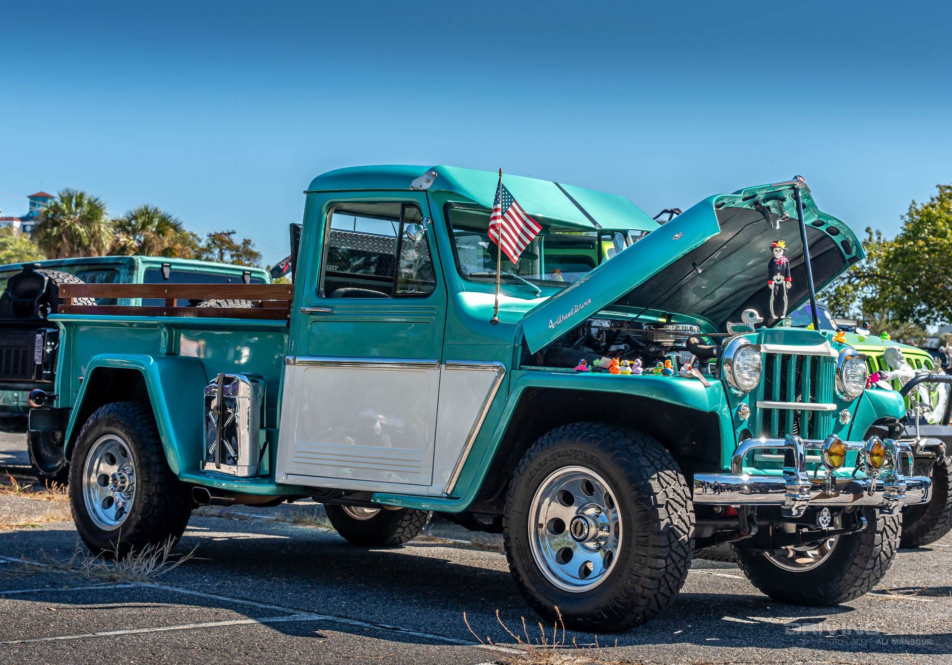 Willys pickup teal and white on Nitto Ridge Grapplers 3/4 front view
