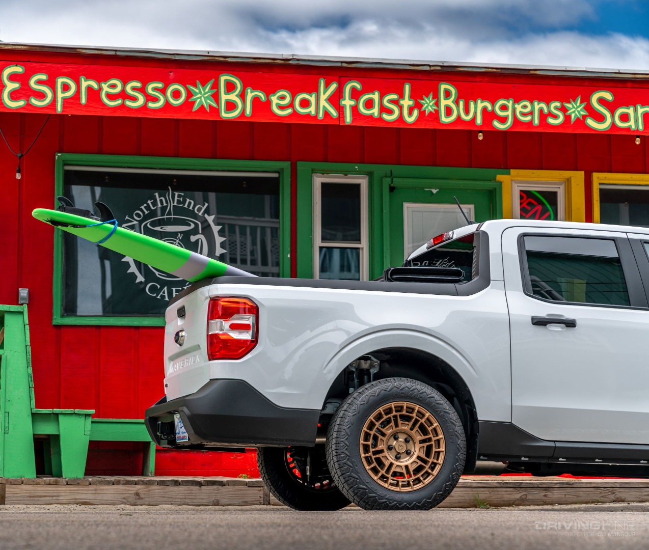 Ford Maverick with surf board sticking out from bed