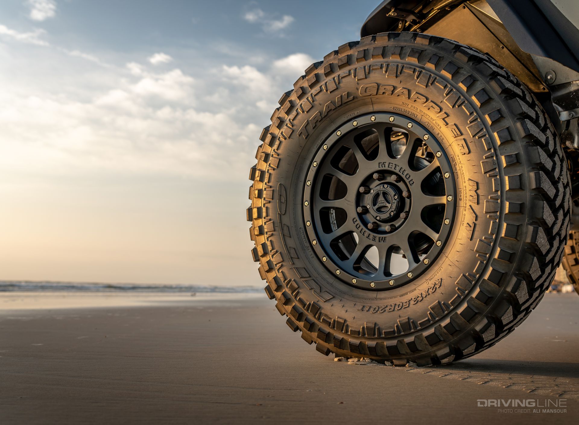 42x13.50R20 Nitto Trail Grappler on Method wheel beach photo side profile