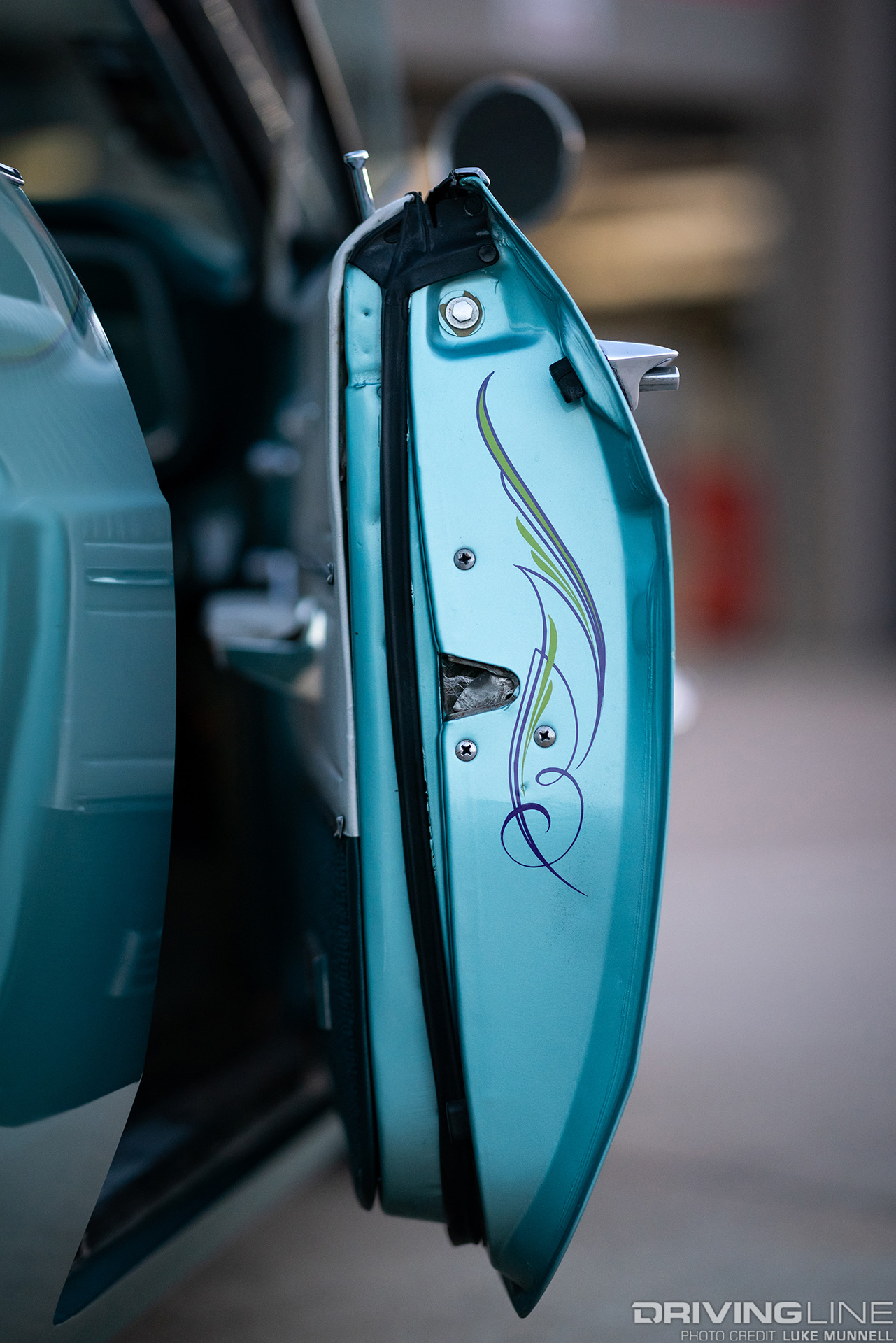 close up of door panel pinstriped 1965 chevy impala with nitto tires